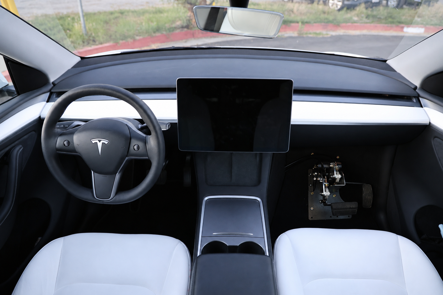 Tesla Model Y interior with instructor dual controls